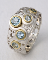 Loop Ring in silver with Aqua-marine stones in yellow gold settings